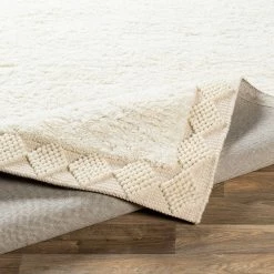 SURYA HAGUE PLUSH WOOL BORDER RUG: CREAM